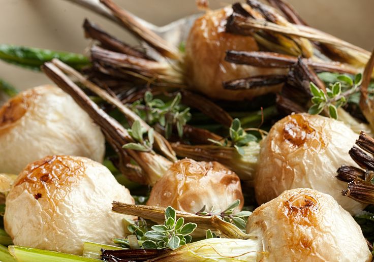 Roasted Japanese style whole turnips with their green tops fried in balsamic vinegar